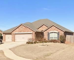 a brick house with a driveway in front of it at Field Stone in Oklahoma City