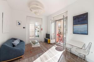 a living room with a couch and a table at BNBHolder Charming & Stylish CHUECA in Madrid