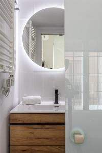 a bathroom with a sink and a mirror at BNBHolder Charming & Stylish CHUECA in Madrid