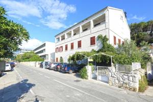 a white building on the side of a street at Apartmani Katarina in Hvar