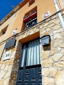 a building with a blue door and a window at Casa rural san juan in San Juan del Monte