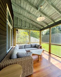 a living room with a couch and a table at Spectacular Views, Private River Access Home in Wilmington
