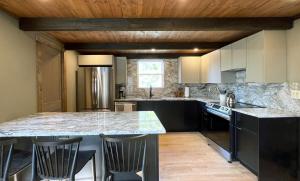 a kitchen with a large island in the middle of it at Spectacular Views, Private River Access Home in Wilmington