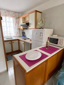 a kitchen with a counter with a white plate on it at Tazacorte Beach and also Luz y Mar apartments in Puerto