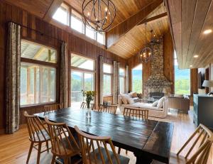 a living room with a large wooden table and chairs at Spectacular Views, Private River Access Home in Wilmington