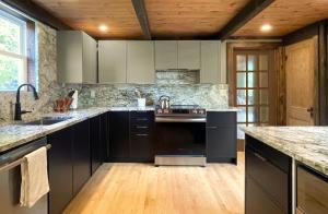 a kitchen with black appliances and a wooden ceiling at Spectacular Views, Private River Access Home in Wilmington +17 photos
