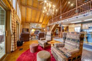 a living room with chairs and a chandelier at Robbinsville Vacation Rental with Covered Balcony in Robbinsville