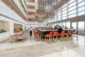 a restaurant with red chairs and a large bar at Beautiful 1 Bedroom Brickell in Miami