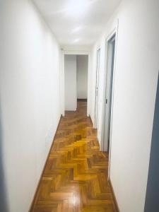 an empty hallway with wooden floors in an apartment at Casa Futura in Rome