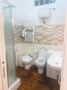 a bathroom with a toilet and a sink and a shower at Casa Futura in Rome