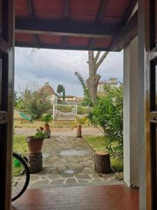 an open door of a house with a patio at Villa Artemisia in Borgo a Buggiano