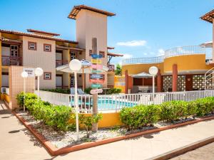 um hotel com piscina em frente a um edifício em Pousada Mares Sergipe em Estância