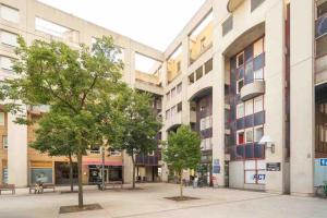 two trees in the courtyard of a building at Zenitude Studio au coeur de Lyon in Lyon