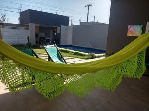 a hammock in front of a swimming pool at VIDA NO PARAISO LAGOINHA in Lagoinha