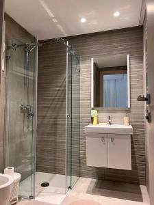a bathroom with a sink and a glass shower at Kenzo Sweet House in La Soukra +20 photos