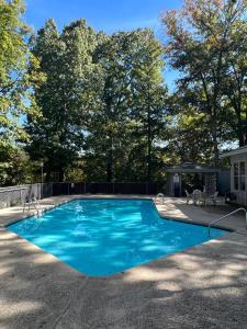a blue swimming pool with a gazebo at Trailside Vacation Home 7 in Bella Vista