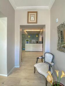 a living room with a chair and a hallway at Pousada atalaia ll in Fortaleza