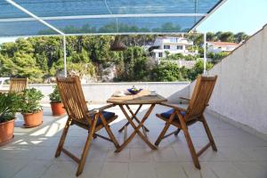 a table and two chairs on a balcony at Apartmani Katarina in Hvar