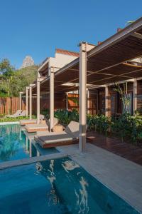 an external view of a house with a swimming pool at POUSADA DO MIRANTE in Fernando de Noronha