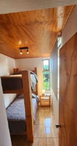 a room with two bunk beds and a hallway at Cabañas Tupuna Lodge in Hanga Roa