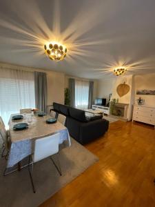 a living room with a table and a couch at Holiday Flat Green Coast in Espinho