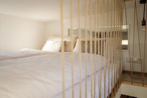 a bedroom with a white bed and a chair at Tiny Om Ferienhaus in Laichingen