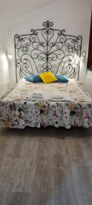a bedroom with a bed with a metal headboard at Casa O Arco Alojamento Local in Marvão +71 photos