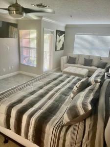 a large bedroom with a large bed and a couch at Theme Park Gateway! in Kissimmee