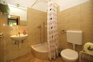 a bathroom with a toilet and a sink and a shower at Apartmani Katarina in Hvar +51 photos
