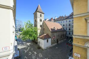 an old building with a clock tower in a city at Central City Apartments in Vienna