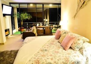 a bedroom with a large bed with pillows on it at Termales Chachimbiro "Fuente de Vida" in Urcuquí