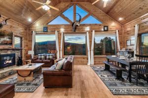 a large living room with a table and a couch at Epic Mountain Views, Hot Tub, Game Room, Sleeps 10 in Sevierville