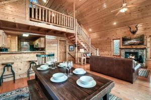 a dining room and living room in a log cabin at Epic Mountain Views, Hot Tub, Game Room, Sleeps 10 in Sevierville