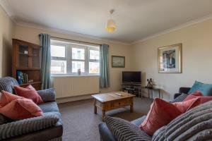 a living room with two couches and a tv at 13 Victoria Road Apartment in Cardiff