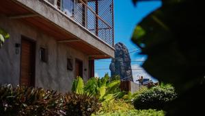 a view of a building with a statue in the foreground at Vila Sal Boutique Noronha in Fernando de Noronha