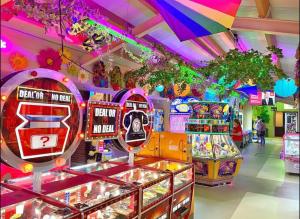 a game room with many pinball machines at LillyPad Caravan in Selsey