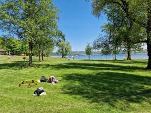 a group of people laying on the grass in a park at Gutshof Alpenblick am Simssee - über den man spricht in Stephanskirchen