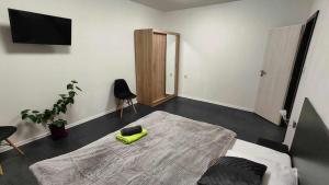 a bedroom with a bed with a yellow pillow on it at Apartmány u golfu in Jihlava