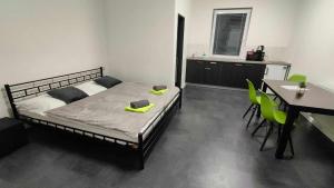 a bedroom with a bed and a table and chairs at Apartmány u golfu in Jihlava