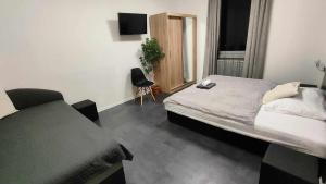 a bedroom with a bed and a chair in it at Apartmány u golfu in Jihlava