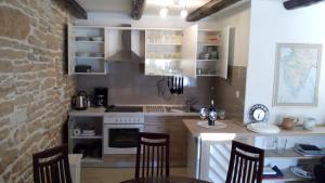 a kitchen with a table and chairs in a room at Holiday Home Peruski in Peruški