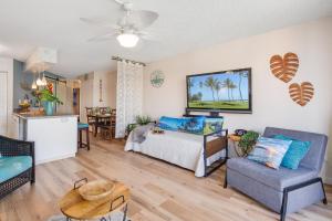 a living room with a bed and a couch at Maui Sunset B402 in Kihei