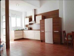 a kitchen with a white refrigerator in a room at Vivienda Planta Baja in Algemesí
