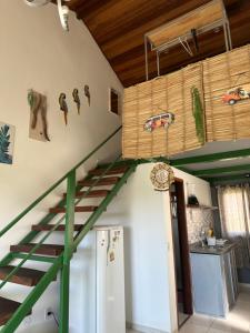 a room with a green staircase with cars on the wall at By Búzios Loft in Búzios