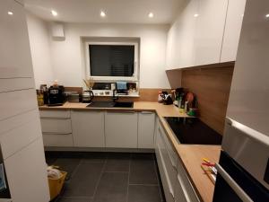 a kitchen with white cabinets and a window at Zimmer 31qm inkl. Duschbad in Hamburg