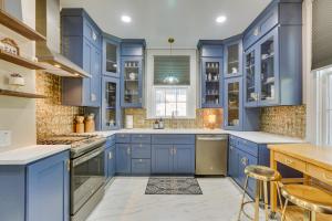a blue kitchen with white counters and blue cabinets at Danville Retreat with Hot Tub and Cozy Fireplace! in Danville