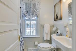a bathroom with a toilet and a sink and a window at Danville Retreat with Hot Tub and Cozy Fireplace! in Danville +26 photos