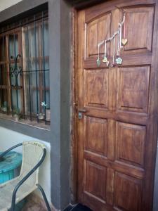 a wooden door with a chair next to a window at Lo de Guille in Oberá