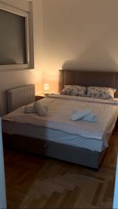 a bedroom with a large bed with two pillows at House Inn 2 in Pirot