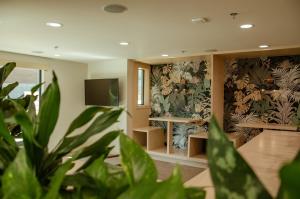 a living room with a potted plant and wallpaper at Brut Hotel in Tulsa